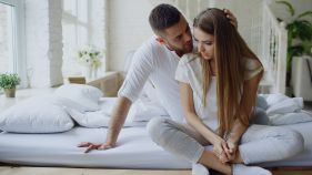 Couple in bed sitting together